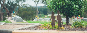 Silhouette of children in a garden at a cemetery