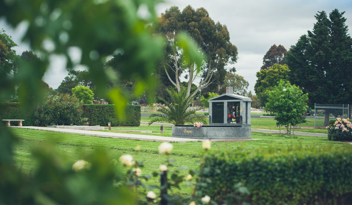 Muslim Monument grave at cemetery, in green lawn with surrounding gardens