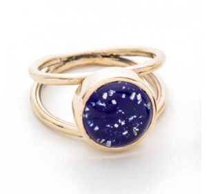 Gold ring with large blue glass circle as a feature
