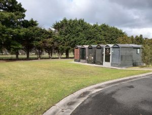 Green lawn beside a line of crypts