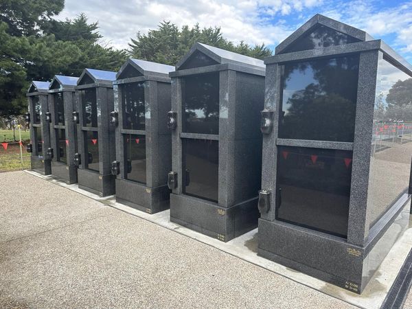 6 black granite crypts in a row