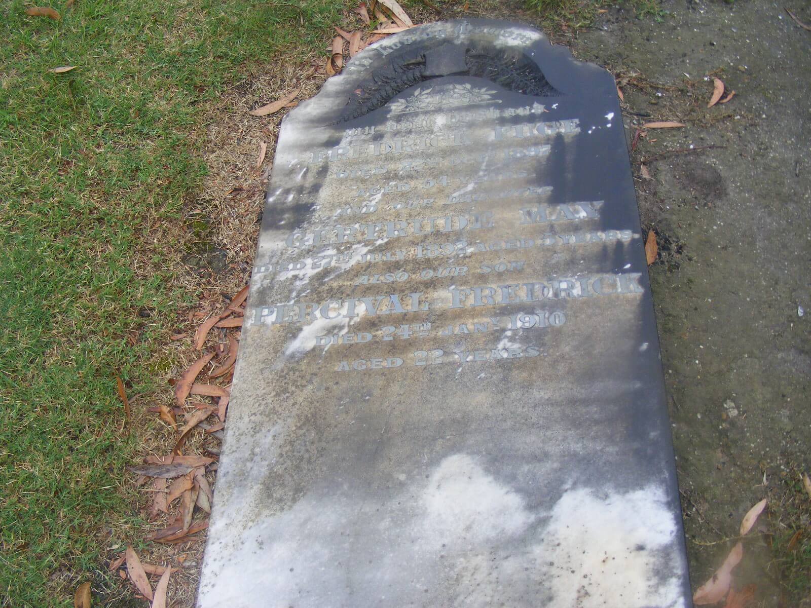 Large headstone lying on the ground.