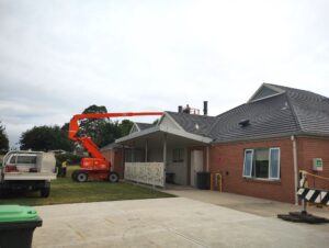 Crane reaching out over roof