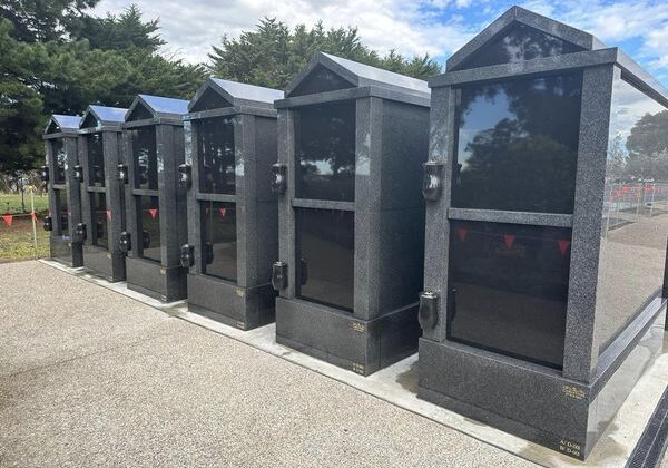 6 black granite crypts in a row