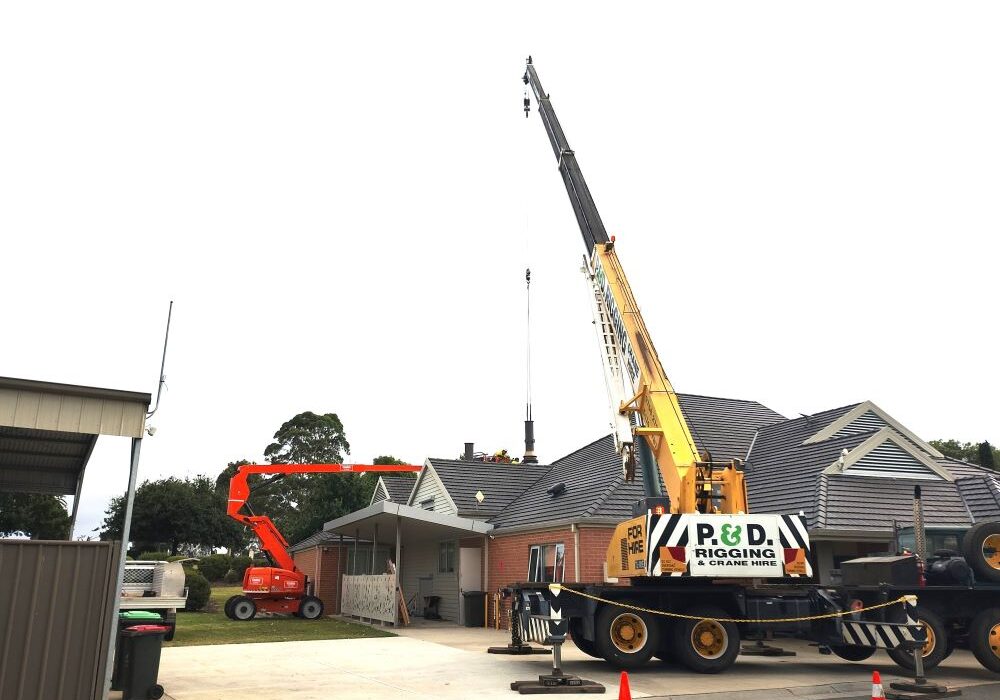 Two cranes working on a roof