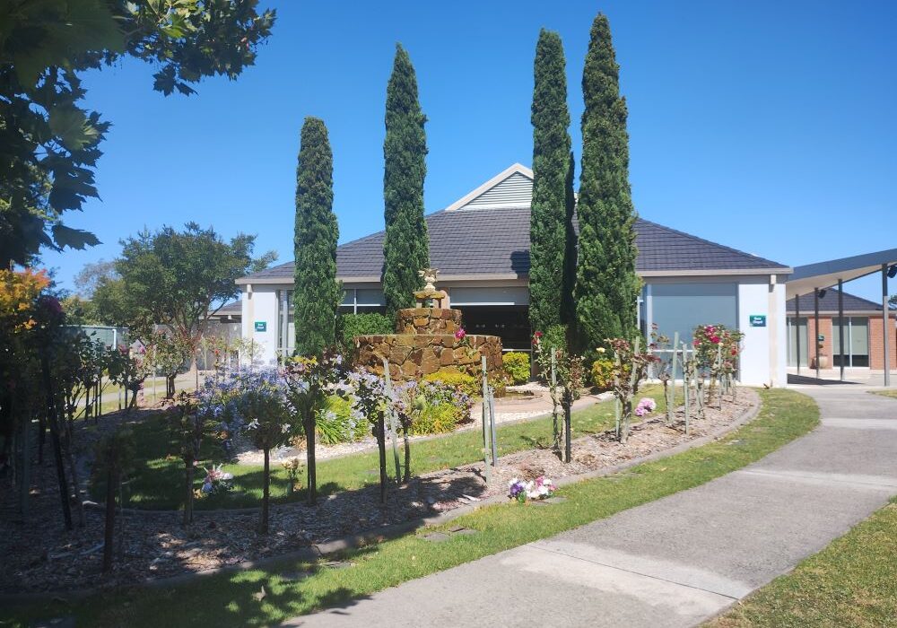 gardens in front of path and building